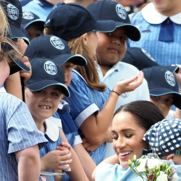 Le prince Harry, duc de Sussex et sa femme Meghan Markle, duchesse de Sussex (enceinte) sont accueillis par des élèves australiens à leur arrivée à Dubbo en Australie dans le cadre de leur première tournée officielle, le 17 octobre 2018.