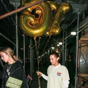 Bella Hadid se rend à l'anniversaire de sa soeur Gigi Hadid avec des ballons dorés à New York, le 23 avril 2019.