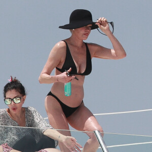 Exclusif - Melanie Griffith en bikini noir sur un yacht lors de ses vacances à Ibiza le 4 juillet 2019.