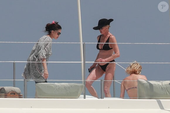 Exclusif - Melanie Griffith en bikini noir sur un yacht lors de ses vacances à Ibiza le 4 juillet 2019.