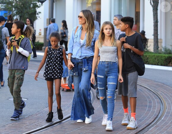 Heidi Klum se promène avec ses enfants, Helene Samuel, Henry Samuel, Lou Samuel et Johan Samuel à The Grove à Hollywood. Le mannequin porte un jean pattes d'eph et une chemise en jean, le 15 octobre 2017.