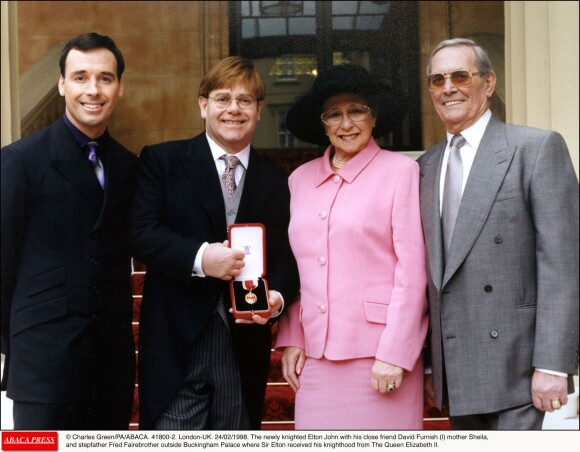 Elton John et David Furnish au côté de Sheila et Fred Fairebrother devant Buckingham Palace le 29 janvier 2003.