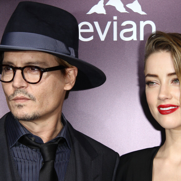 Johnny Depp et sa fiancée Amber Heard à la première du film "3 Days to Kill" à Hollywood, le 12 février 2014.
