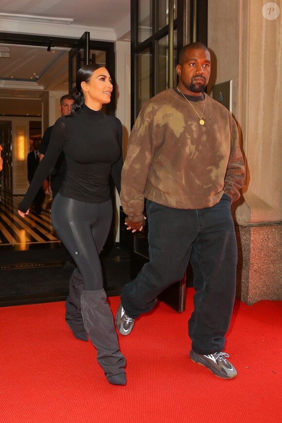 Kim Kardashian et son mari Kanye West main dans la main à la sortie de leur hôtel le lendemain de la soirée du Met Gala à New York, le 7 mai 2019.