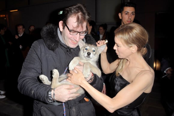 Renée Zellweger prend un petit chiot dans ses bras à la sortie de l'avant-première du film "Judy" au cinéma Gaumont Marignan à Paris, le 4 février 2020.