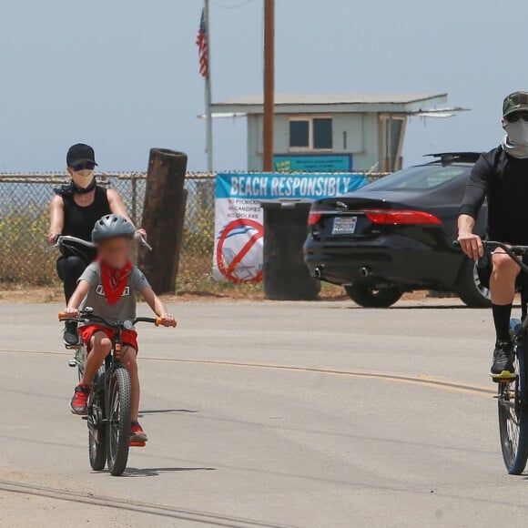 Exclusif - Reese Witherspoon et son mari Jim Toth, munis de masques de protection contre le coronavirus (Covid-19), se promènent à vélo avec leur fils de 7 ans, Tennessee, en bord de mer. Malibu, le 31 mai 2020.