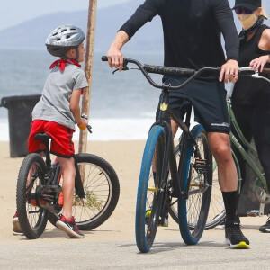 Exclusif - Reese Witherspoon et son mari Jim Toth, munis de masques de protection contre le coronavirus (Covid-19), se promènent à vélo avec leur fils de 7 ans, Tennessee, en bord de mer. Malibu, le 31 mai 2020.