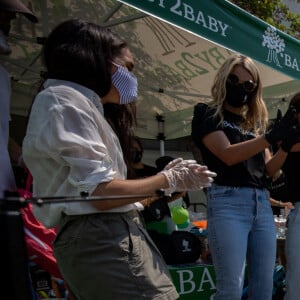 Le prince Harry et Meghan Markle lors d'une distribution de fournitures scolaires devant une école primaire de Los Angeles, le 19 août 2020.