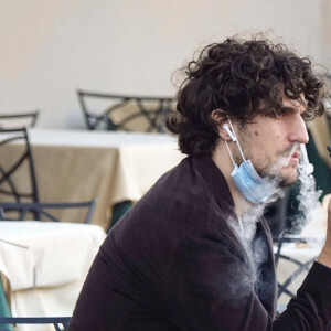 Louis Garrel prend un café à Rome avant d'être rejoint par ses amis Ginevra Elkann et Alba Rohrwacher pour un apéritif en terrasse. Le 18 novembre 2020.