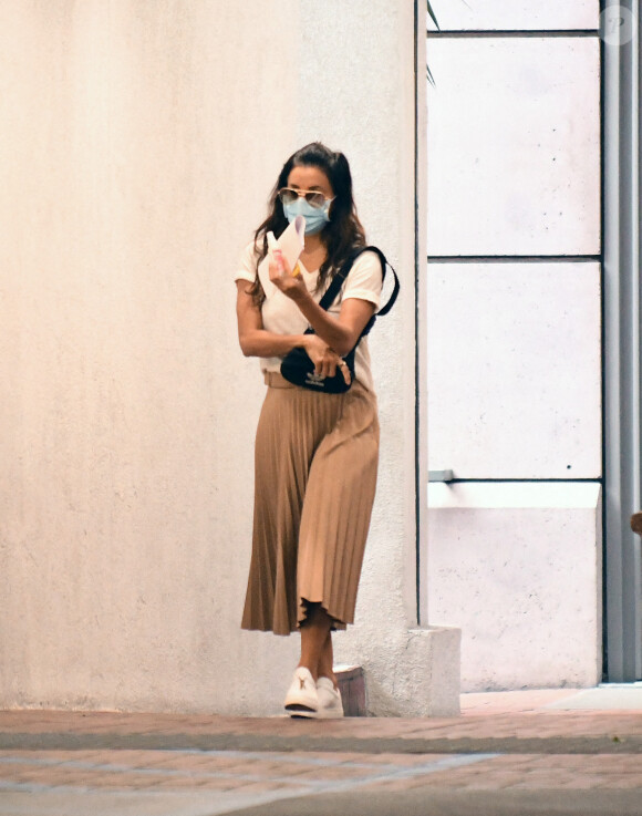 Eva Longoria masquée, robe plissée marron et baskets blanches va faire du shopping à Los Angeles le 9 décembre 2020. 