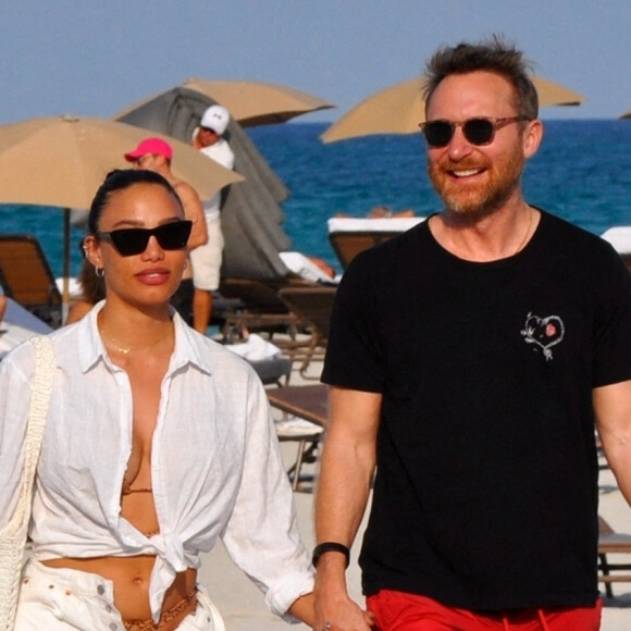 David Guetta et sa compagne Jessica Ledon, avec son ami le DJ Cédric Gervais et sa fiancée Adriana Gutierrez, sur la plage du palace Setai à Miami, le 20 mars 2022.