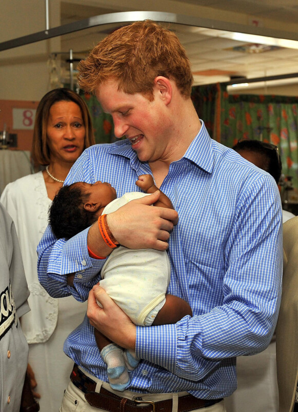 Prince Harrry à la Barbade, attedri par un bébé barbadien (29 janvier 2010)