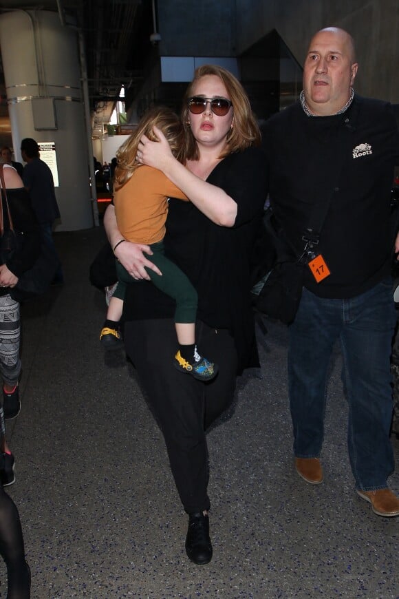 La chanteuse Adele et son fils Angelo Konecki arrivent à l'aéroport LAX de Los Angeles le 3 janvier 2015 entourés de nombreux photographes. La chanteuse serait selon certaines sources séparée de son mari Simon Konecki.