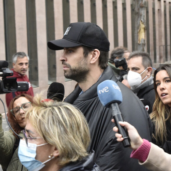 Gerard Piqué sort du tribunal de Barcelone avec son avocat Ramón Tamborero après une audience de première instance dans le cadre de sa séparation avec la chanteuse Shakira le 1er décembre 2022.