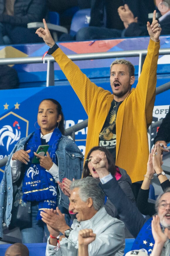 M. Pokora, sa femme Christina Milian assistent au match de la 5e et avant-dernière journée de Ligue des nations entre la France et l'Autriche au Stade de France à Saint-Denis. Le 22 septembre 2022. 