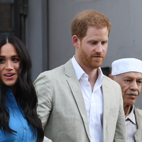 Le prince Harry, duc de Sussex, et Meghan Markle, duchesse de Sussex, participent à un atelier de cuisine communautaire au Homecoming Center au Cap dans le cadre d'une visite officielle, le 23 septembre 2019. 