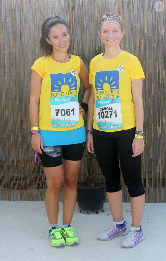 Fabienne Carat et sa soeur Carole lors de la course "La Parisienne 2014" au Champs de Mars à Paris, le 14 septembre 2014.