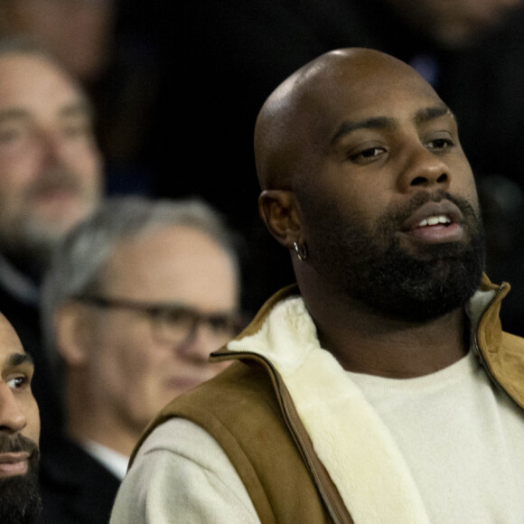 Teddy Riner, Niels Schneider - Célébrités dans les tribunes du match aller des huitièmes de finale de la Ligue des champions entre le PSG et la Real Sociedad (2-0) au Parc des Princes à Paris le 14 février 2024. © Cyril Moreau/Bestimage