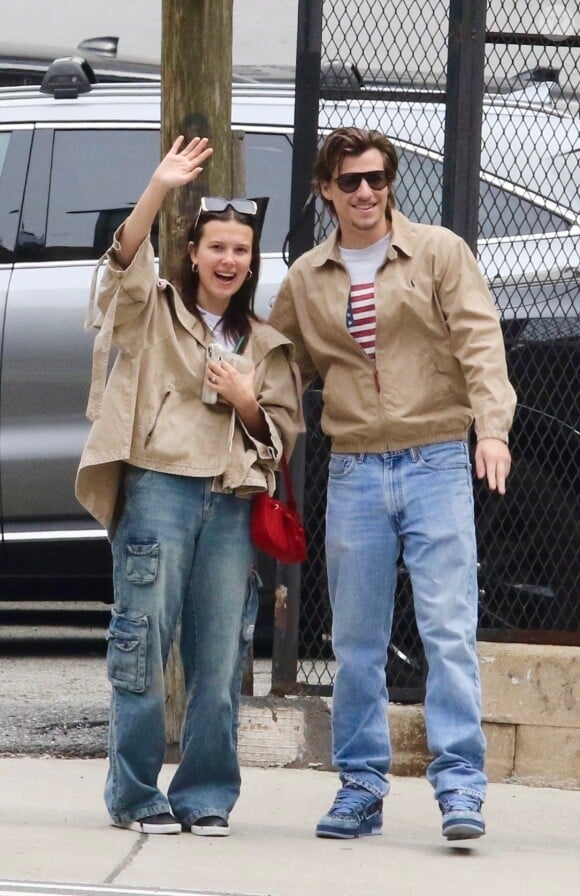 EXCLUSIVE - Millie Bobby Brown and her fiance Jake Bongiovi are all smiles as they coordinate in style sporting color-matching jackets and jeans during a romantic outing in Manhattan’s Downtown area. The engaged couple were in great spirits as they happily waved to the photographer. Millie is currently filming the final season of Stranger Things. SHOT ON 04/19/2024 