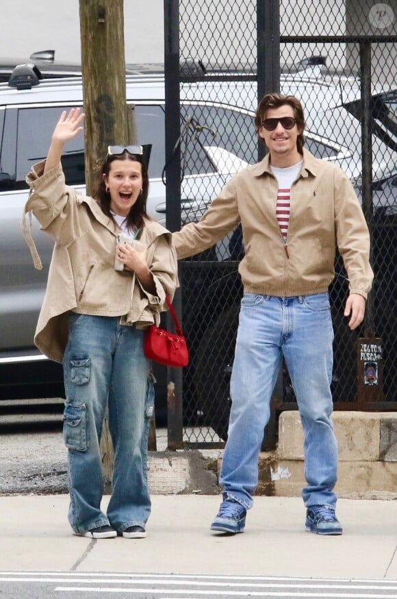 EXCLUSIVE - Millie Bobby Brown and her fiance Jake Bongiovi are all smiles as they coordinate in style sporting color-matching jackets and jeans during a romantic outing in Manhattan’s Downtown area. The engaged couple were in great spirits as they happily waved to the photographer. Millie is currently filming the final season of Stranger Things. SHOT ON 04/19/2024 