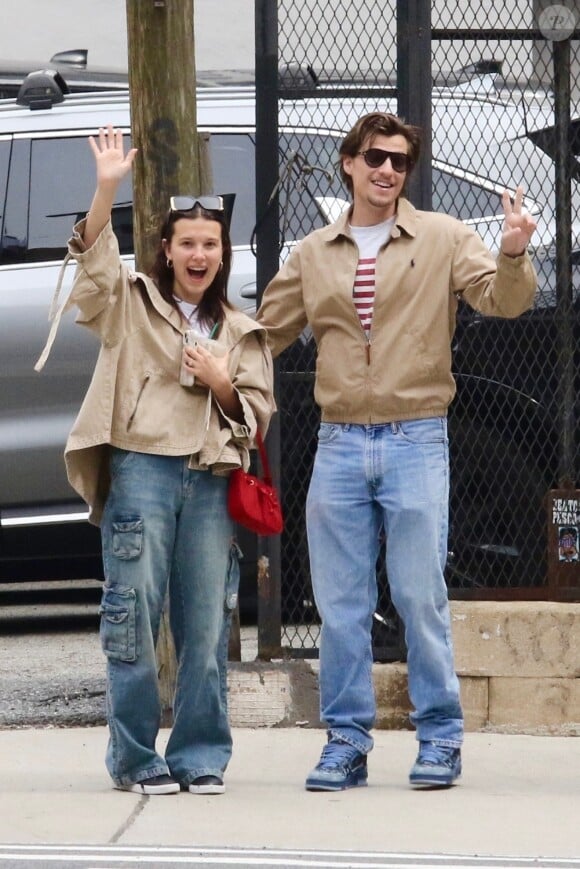 EXCLUSIVE - Millie Bobby Brown and her fiance Jake Bongiovi are all smiles as they coordinate in style sporting color-matching jackets and jeans during a romantic outing in Manhattan’s Downtown area. The engaged couple were in great spirits as they happily waved to the photographer. Millie is currently filming the final season of Stranger Things. SHOT ON 04/19/2024 