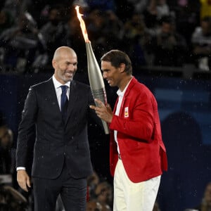 Rafael Nadal reçoit la flamme olympique des mains de Zinedine Zidane lors de la cérémonie d'ouverture des Jeux Olympiques de Paris 2024 au Trocadéro à Paris (France), le 26 juillet 2024. Inside/Panoramic/Bestimage