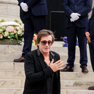 Thomas Dutronc, la main sur le coeur en guise de remerciement envers la foule d'admirateurs venue nombreuse pour rendre un dernier hommage à sa mère - Sortie des obsèques de l'auteure-compositrice-interprète et actrice française Françoise Hardy au crématorium du cimetière du Père-Lachaise à Paris, France, le 20 juin 2024. © Jacovides-Moreau/Bestimage 