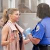 Fergie, à l'aéroport de Los Angeles, se fait fouiller par un agent au sol, lors de son passage au contrôle de sécurité. 17 avril 2011