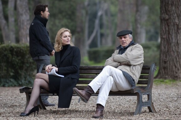 Eva Herzigova et le réalisateur Marco Risi assis sur un banc, tournent le film Cha Cha Cha à Rome. Le 5 mars 2012.