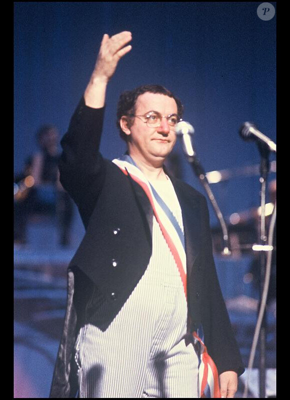 Coluche.