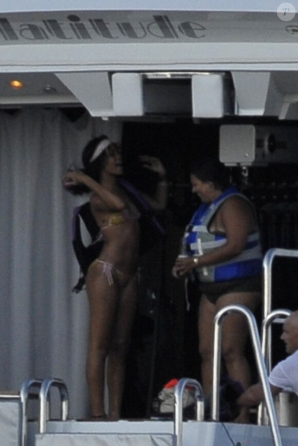Rihanna enfile son gilet avant de grimper sur sa bouée et de chevaucher la mer. Capri, le 18 juillet 2012.