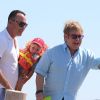 Elton John, son compagnon David Furnish et leur fils Zachary arrivent au Club 55 à Saint-Tropez le 2 août 2012