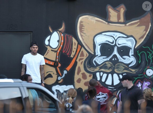 Chris Brown fait des graffitis pour une oeuvre de charité sur un mur à Miami, le 26 mars 2013.