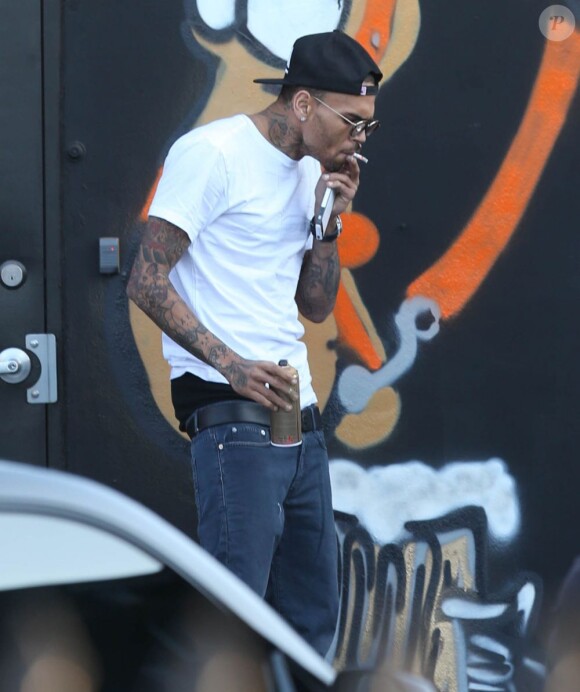 Chris Brown fait des graffitis pour une oeuvre de charité sur un mur à Miami, le 26 mars 2013.