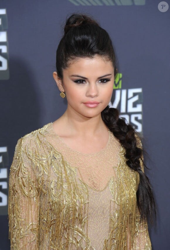 Selena Gomez, star incontestée des MTV Movie Awards, porte à son arrivée une robe Julien Macdonald collection automne 2013 et des souliers Jimmy Choo. Los Angeles, le 14 avril 2013.