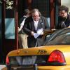 Gérard Depardieu est en train de lire le scenario du film sur DSK d'Abel Ferrara en sortant de son hôtel à New York le 14 avril 2013