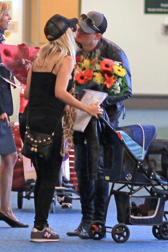 Le chanteur Michael Bublé accueille sa femme Luisana Lopilato, enceinte, avec un bouquet de fleurs à l'aéroport de Vancouver, le 15 juin 2013. Galant, le chanteur lui a apporté des fleurs. Michael Bublé a été vu en train de pousser une poussette... qui transportait leur chien.