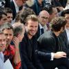 Marc Jacobs (en rouge), le président de Louis Vuitton Michael Burke, David Beckham, Antoine Arnault et Pio Marmaï assistent au défilé Louis Vuitton printemps-été 2014 au parc André Citroën. Paris, le 27 juin 2013.