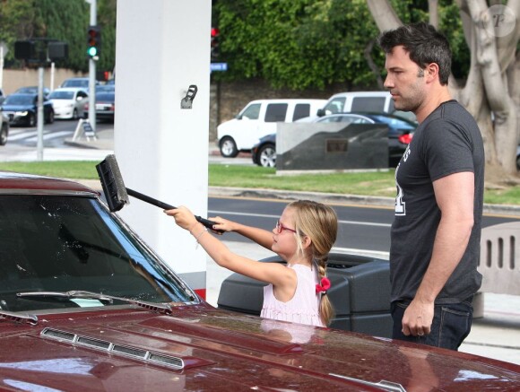 Ben Affleck apprend à sa fille Violet comment laver le pare-brise de leur voiture à Brentwood, le 23 juillet 2013. Une séquence de "car-wash" adorable