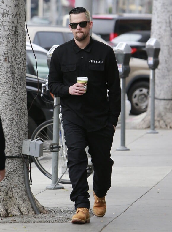 Joel Madden, presque tout de noir vêtu avec des lunettes Ray-Ban Wayfarer, une chemise Supreme et des bottines Timberland à Beverly Hills. Le 18 mars 2013.