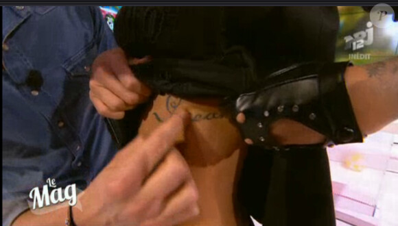 Le tatouage de Caroline Receveur transformée en Catwoman dans Le Mag de NRJ12 le 7 janvier 2014