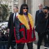 Rihanna arrive au Conseil économique et social pour assister au défilé Miu Miu. Elle porte un manteau, une robe-pull décolletée et un foulard violet Prada, des bas et des sandales noirs. Paris, le 5 mars 2014.
