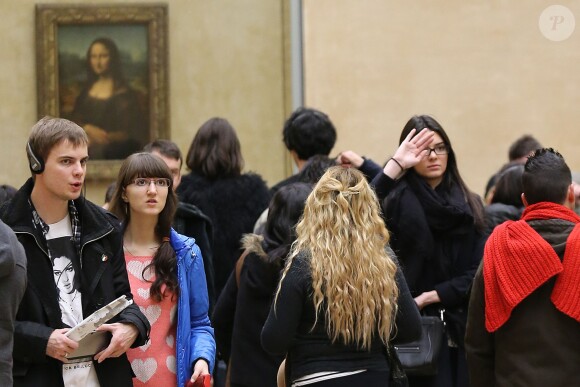 Kendall Jenner pose devant la Joconde en visite musée du Louvre à Paris avec une amie, le 1er mars 2014.