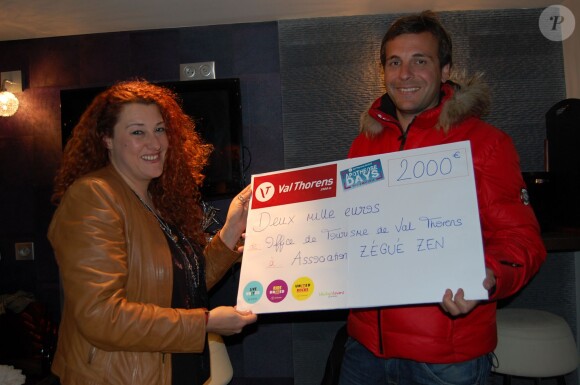 Emma Shaka recevant des mains de Grégory Guzzo, directeur de l'Office de tourisme de Val Thorens, un chèque de 2000 euros au profit de l'association Zégué Zen, le 2 mai 2014.