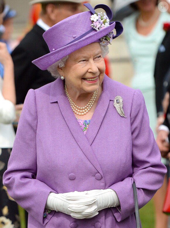 La reine Elizabeth II était vêtue d'un ensemble lavande Angela Kelly le 21 mai 2014 dans le parc de Buckingham Palace pour la première garden party de l'année.