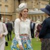 La princesse Beatrice d'York, ravissante dans une jupe Mary Katrantzou etun chemisier Juicy Couture, et coiffée d'un chapeau Robyn Coles, participait avec la reine Elizabeh II et le duc d'Edimbourg, le 21 mai 2014 dans le parc de Buckingham Palace, à la première garden party royale de l'année.