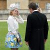 La princesse Beatrice d'York, ravissante dans une jupe Mary Katrantzou etun chemisier Juicy Couture, et coiffée d'un chapeau Robyn Coles, participait avec la reine Elizabeh II et le duc d'Edimbourg, le 21 mai 2014 dans le parc de Buckingham Palace, à la première garden party royale de l'année.
