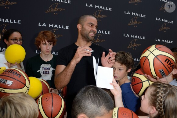 Tony Parker lors d'un événement organisé par la Halle au Carreau du Temple à Paris, le 2 juillet 2014, au milieu de dizaines d'enfants