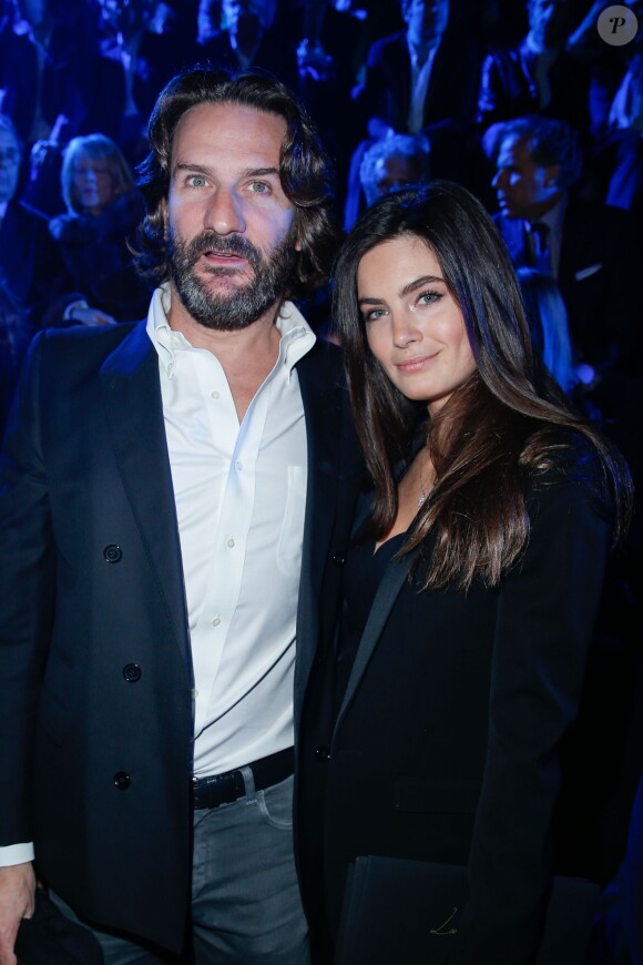 Frédéric Beigbeder et Lara Micheli au défilé de la collection Natalia pour Etam à la Bourse du Commerce à Paris, le 25 février 2014.