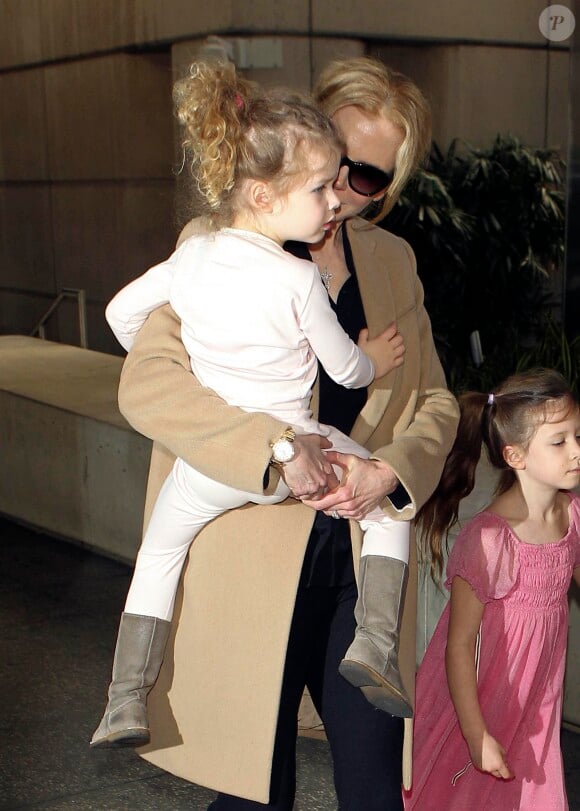 Nicole Kidman avec ses filles Faith dans les bras et Sunday à ses côtés, rentrant à Los Angeles le 23 septembre 2014. Elles étaient en Australie en famille pour les obsèques du père de la comédienne, Antony Kidman